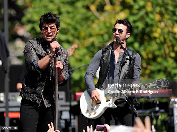 Musician Joe Jonas and musician Kevin Jonas perform live at the Grove to kick off the summer concert series on May 15, 2010 in Los Angeles,...