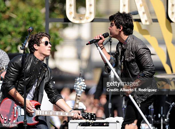 Musician Nick Jonas and musician Joe Jonas perform live at the Grove to kick off the summer concert series on May 15, 2010 in Los Angeles, California.