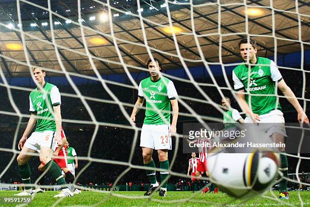 Tim Borowski, Hugo Almeida and Sebastian Boenisch of Bremen look dejected after getting a goal during the DFB Cup final match between SV Werder...