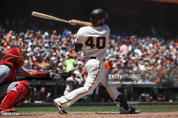 Madison Bumgarner of the San Francisco Giants hits a single against the St. Louis Cardinals during the fourth inning at AT&T Park on July 8, 2018 in...