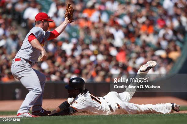 Alen Hanson of the San Francisco Giants slides into third base ahead of a tag from Jedd Gyorko of the St. Louis Cardinals during the fifth inning at...