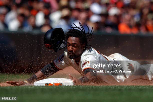 Alen Hanson of the San Francisco Giants slides into third base against the St. Louis Cardinals during the fifth inning at AT&T Park on July 8, 2018...