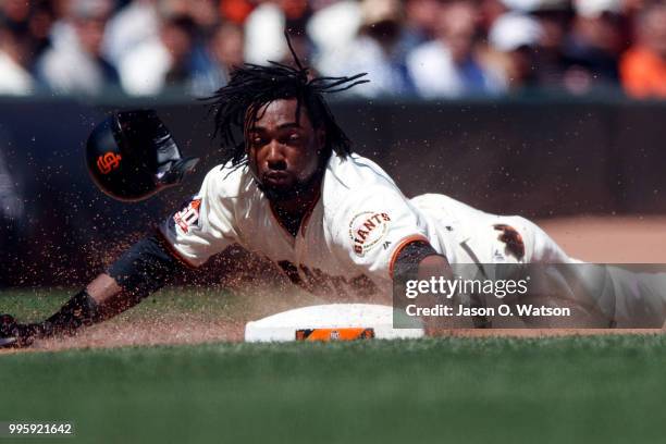 Alen Hanson of the San Francisco Giants slides into third base against the St. Louis Cardinals during the fifth inning at AT&T Park on July 8, 2018...