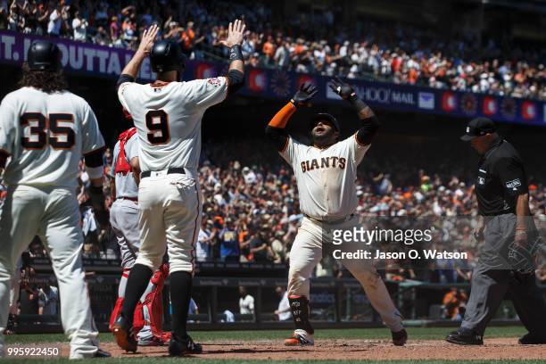 Pablo Sandoval of the San Francisco Giants celebrates with Brandon Belt and Brandon Crawford after hitting a three run home run against the St. Louis...