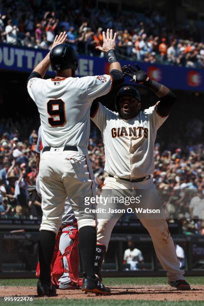 Pablo Sandoval of the San Francisco Giants celebrates with Brandon Belt after hitting a three run home run against the St. Louis Cardinals during the...