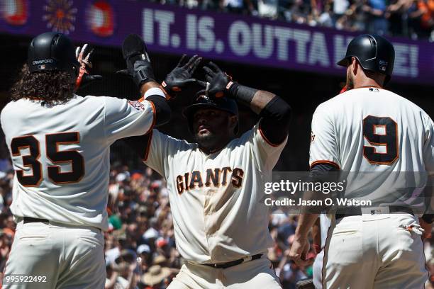 Pablo Sandoval of the San Francisco Giants celebrates with Brandon Belt and Brandon Crawford after hitting a three run home run against the St. Louis...
