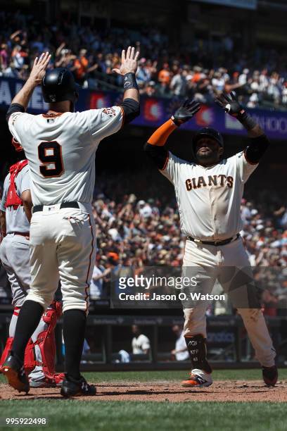 Pablo Sandoval of the San Francisco Giants celebrates with Brandon Belt after hitting a three run home run against the St. Louis Cardinals during the...
