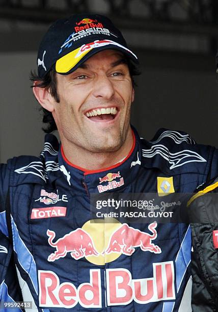 Red Bull's Australian driver Mark Webber celebrates in the parc ferme of the Monaco street circuit on May 15 after the qualifying session of the...