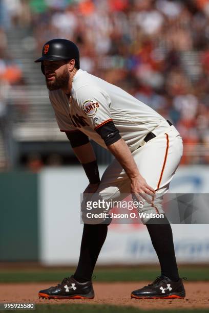 Brandon Belt of the San Francisco Giants leads off first base against the St. Louis Cardinals during the seventh inning at AT&T Park on July 8, 2018...