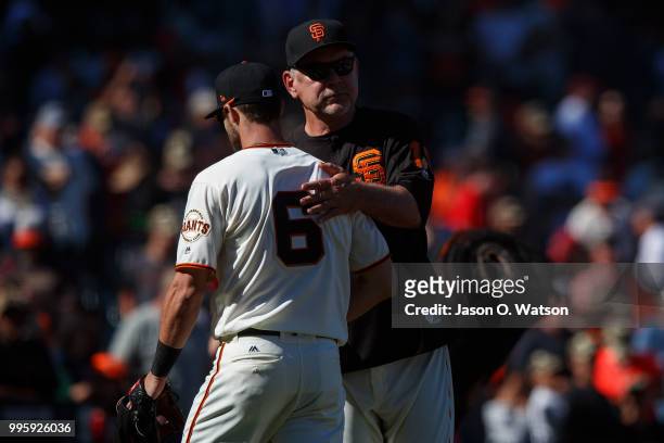 Steven Duggar of the San Francisco Giants celebrates with manager Bruce Bochy after the game against the St. Louis Cardinals at AT&T Park on July 8,...