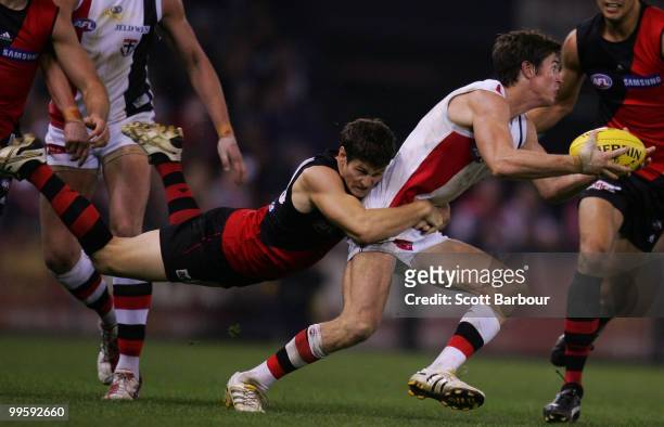 Lenny Hayes of the Saints is tackled by Ben Howlett of the Bombers during the round eight AFL match between the St Kilda Saints and the Essendon...