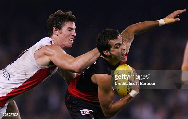 Courtenay Dempsey of the Bombers is tackled during the round eight AFL match between the St Kilda Saints and the Essendon Bombers at Etihad Stadium...