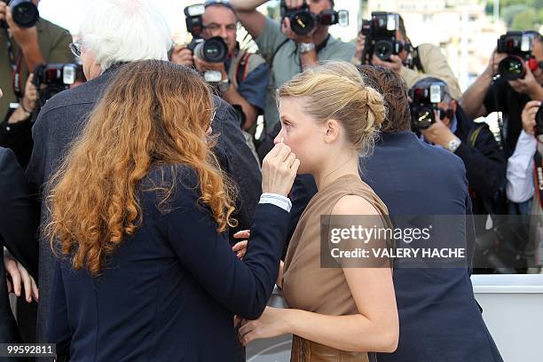 Make up artist correct the make up of French actress Melanie Thierry as she poses during the photocall of "La Princesse de Montpensier" presented in...