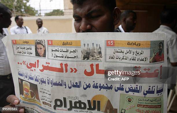 Sudanese man reads today's issue of the local Al-Ahram newspaper with the front page main title in red: "The Detention of Turabi", during a protest...