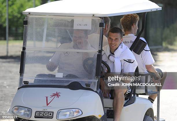 Germany's striker Lukas Podolski drives a golf cart following a training session at the Verdura Golf and Spa resort, near Sciacca on May 16, 2010....