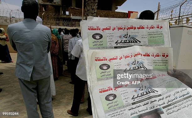 Sudanese man holds three archive copies of "Rai al-Shaab" newspaper which was confiscated on May 16, 2010 during a protest by supporters of...