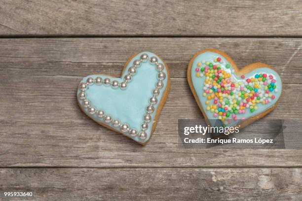 two baked hearts covered with blue icing - animal internal organ stockfoto's en -beelden