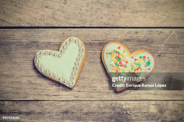 two baked hearts covered with blue icing - animal internal organ stockfoto's en -beelden