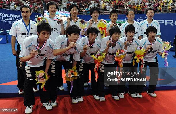 Silver medalists of Japan pose for pictures during the podium ceremony for the Thomas Cup badminton championships in Kuala Lumpur on May 16, 2010. A...