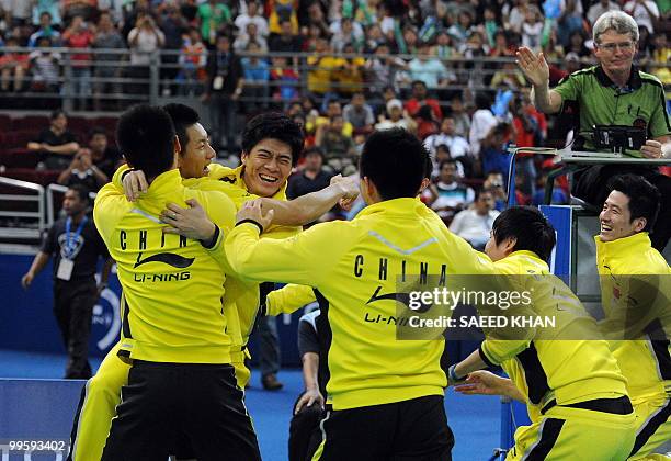 China's team players greet their player Chen Jin after he defeated Indonesia's Simon Santoso in the finals round of the Thomas Cup badminton...