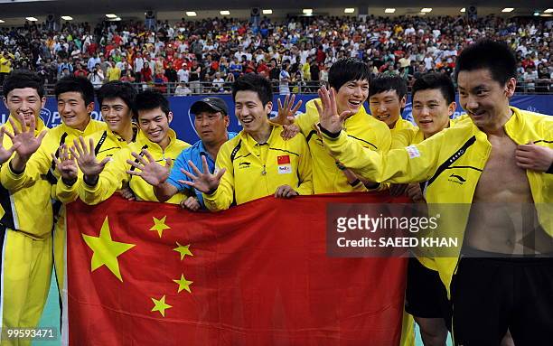 China's team members celebrate their victory over Indonesia in the finals round of the Thomas Cup badminton championships in Kuala Lumpur on May 16,...