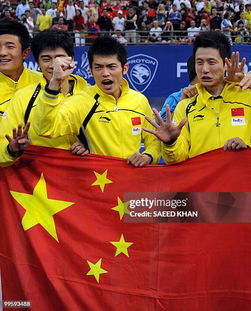 China's Lin Dan shouts along with teammates after China defeated Indonesia in the finals round of the Thomas Cup badminton championships in Kuala...