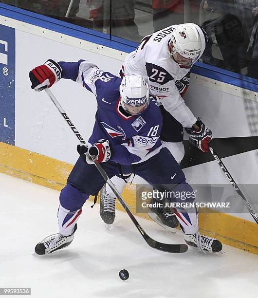 S David Moss vies with France's Yohann Auvitu during the IIHF Ice Hockey World Championship match France vs USA in the western German city of Cologne...