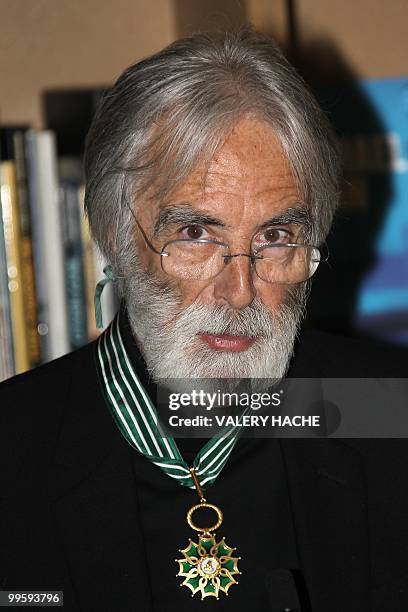 Austrian writer-director Michael Haneke poses after receiving the Commandeur de l'Ordre des Arts et des Lettres from French Culture Minister Frederic...