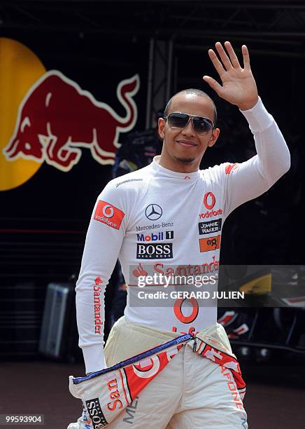 McLaren Mercedes' British driver Lewis Hamilton waves as he arrives in the pits of the Monaco street circuit on May 15 for the qualifying session of...