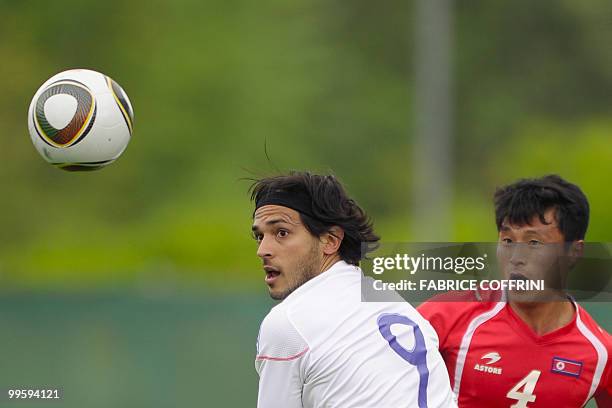 Paraguay's Roque Santa Cruz vies for the ball with North Korea's Pak Nam Chol during a friendly football game in Nyon on May 15, 2010 ahead of their...