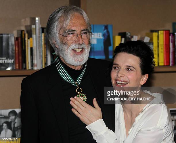 Austrian writer-director Michael Haneke poses with French actress Juliette Binoche after receiving the Commandeur de l'Ordre des Arts et des Lettres...