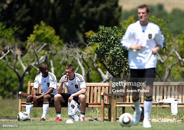 Cacau and Lukas Podolski of Germany are pictured after the German National Team training session at Verdura Golf and Spa Resort on May 16, 2010 in...