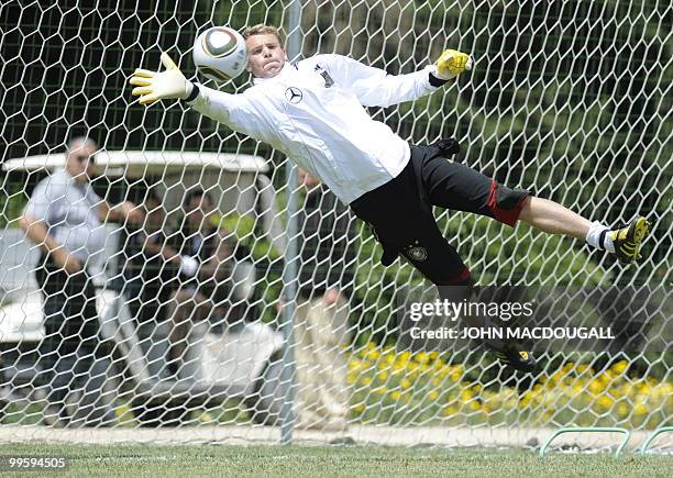 Germany's goalkeeper Manuel Neuer goes for a save during a training session at the Verdura Golf and Spa resort, near Sciacca May 16, 2010. The German...