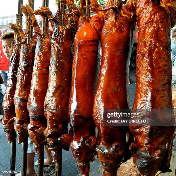 Roasted pigs are sold in La Loma district of Manila on May 16 during an annual festival. Roast pigs, called 'lechon' remain hugely popular in the...