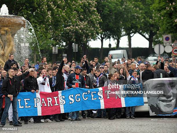 People hold a banner reading "Paris SG, it's us" during a "pacific" demonstration of French "Virage d'Auteuil" group of supporters of Paris...