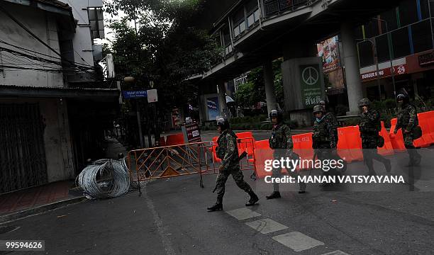 Thai soldiers patrol the deserted and heavily barricaded popular Silom Road in Bangkok's central financial district on May 16, 2010. Thailand's army...