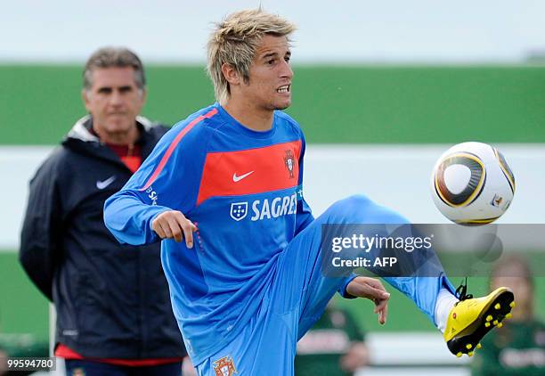 Portugal's Fabio Coentrao controls the ball as coach Carlos Queiroz looks on during the team's second training session at Santos Pinto Stadium in...