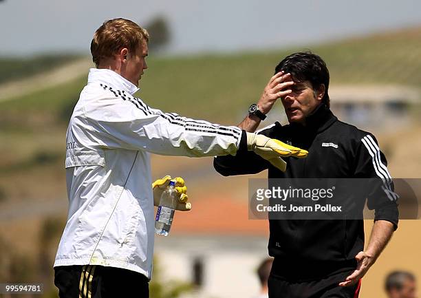 Head coach Joachim Loew of Germany talks to Manuel Neuer of Germany during the German National Team training session at Verdura Golf and Spa Resort...