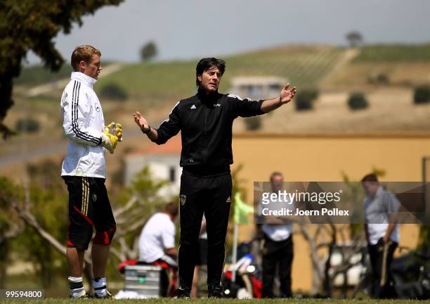 Head coach Joachim Loew of Germany talks to goalkeeper Manuel Neuer of Germany during the German National Team training session at Verdura Golf and...