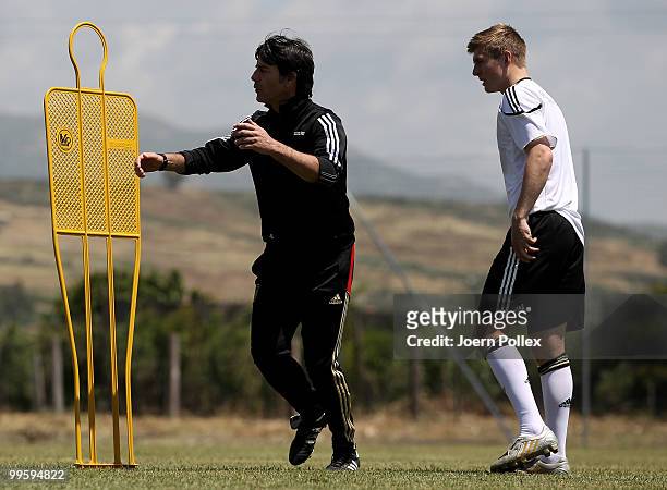 Head coach Joachim Loew of Germany talks to Toni Kroos during the German National Team training session at Verdura Golf and Spa Resort on May 16,...