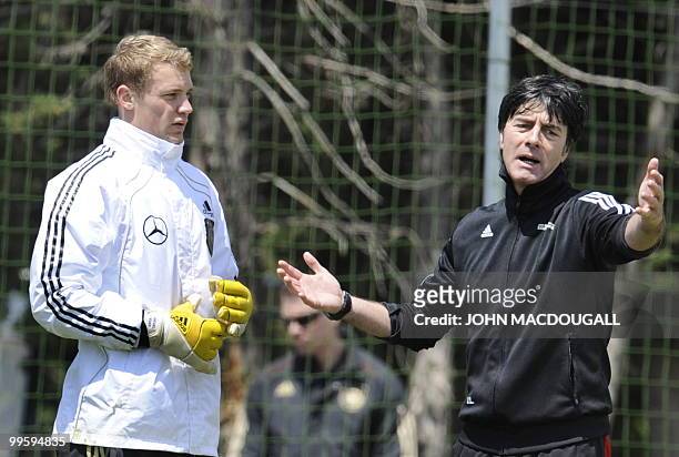 Germany's goalkeeper Manuel Neuer speaks with Germany's head coach Joachim Loew during a training session at the Verdura Golf and Spa resort, near...