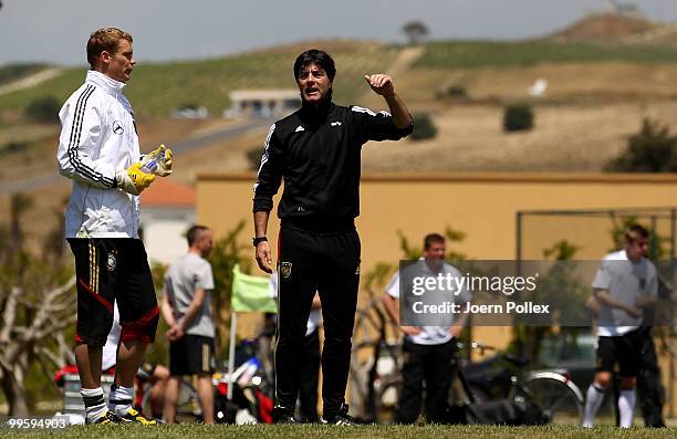 Head coach Joachim Loew of Germany talks to Manuel Neuer during the German National Team training session at Verdura Golf and Spa Resort on May 16,...