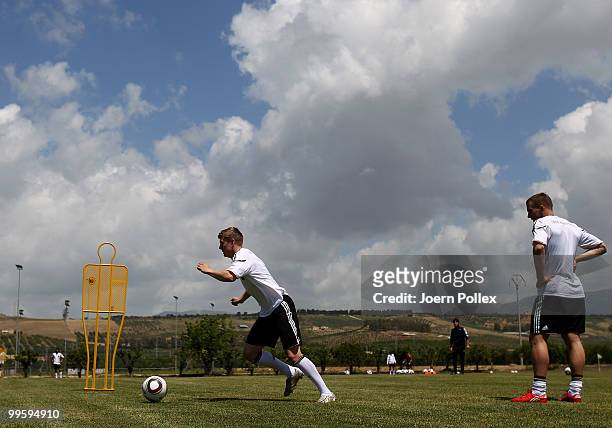 Toni Kroos and Lukas Podolski of Germany are seen in action during the German National Team training session at Verdura Golf and Spa Resort on May...