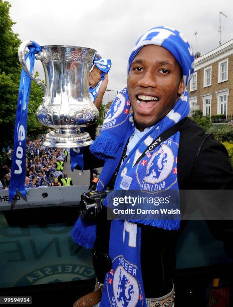 Didier Drogba of Chelsea poses with the FA Cup trophy during the Chelsea Football Club Victory Parade on May 16, 2010 in London, England.