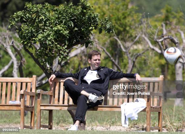 Team manager Oliver Bierhoff of Germany sits on a bench during the German National Team training session at Verdura Golf and Spa Resort on May 16,...