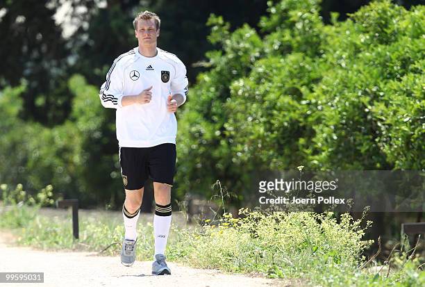 Marcell Jansen of Germany is seen jogging n during the German National Team training session at Verdura Golf and Spa Resort on May 16, 2010 in...