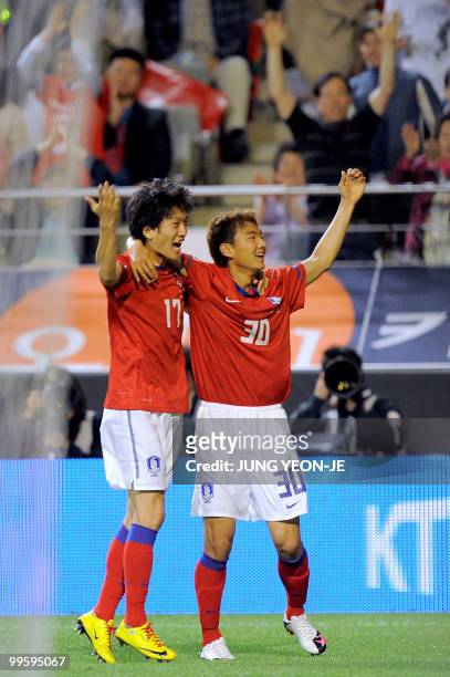 South Korea's Lee Seung-Ryol celebrates his goal with his teammate Lee Choung-Yong against Ecuador during a friendly football match in Seoul on May...