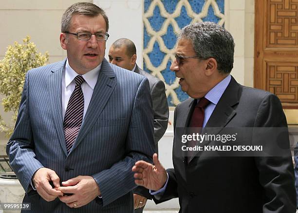 Arab League secretary general Amr Mussa speaks with Belgian Foreign Minister Steven Vanackere as they leave following their meeting in Cairo on May...