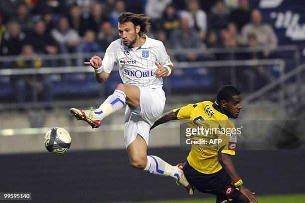 Auxerre's French defender Cedric Hengbart kicks the ball to score despite FC Sochaux' defender Jacques Faty during the French L1 football match...