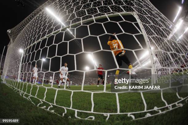 Umm Salal's Baba Malik watches the ball hit the net as Al-Rayyan score their first goal in the Qatari Emir Cup final football match in Doha on May...